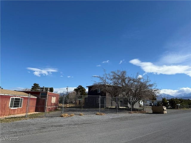 view of front of property featuring a mountain view and fence