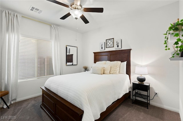 bedroom featuring dark carpet, baseboards, and a ceiling fan