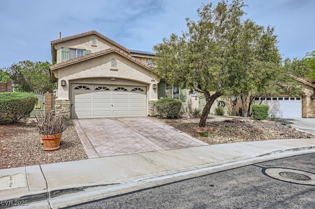 215 Sunset Shower Dr, Henderson, NV 89012 - view of front of property with roof mounted solar panels, driveway, stone siding, and stucco siding