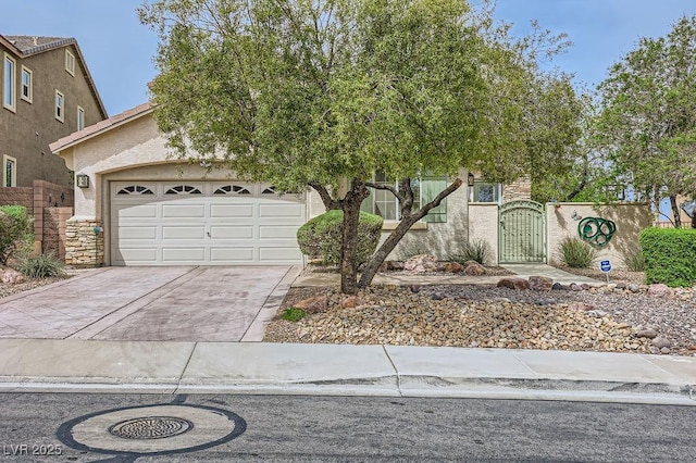 215 Sunset Shower Dr, Henderson, NV 89012 - obstructed view of property with driveway, a gate, stucco siding, and an attached garage