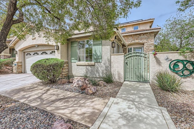 215 Sunset Shower Dr, Henderson, NV 89012 - view of front of property with concrete driveway, stone siding, a gate, an attached garage, and stucco siding