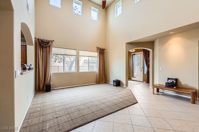 215 Sunset Shower Dr, Henderson, NV 89012 - foyer entrance with a towering ceiling, baseboards, light tile patterned flooring, and arched walkways