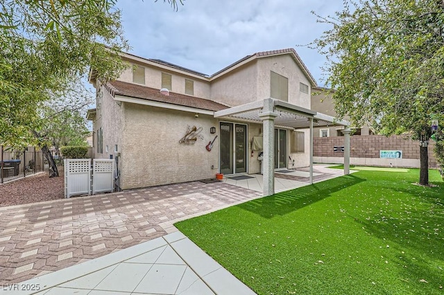 215 Sunset Shower Dr, Henderson, NV 89012 - back of house featuring stucco siding, fence, a yard, and a patio area