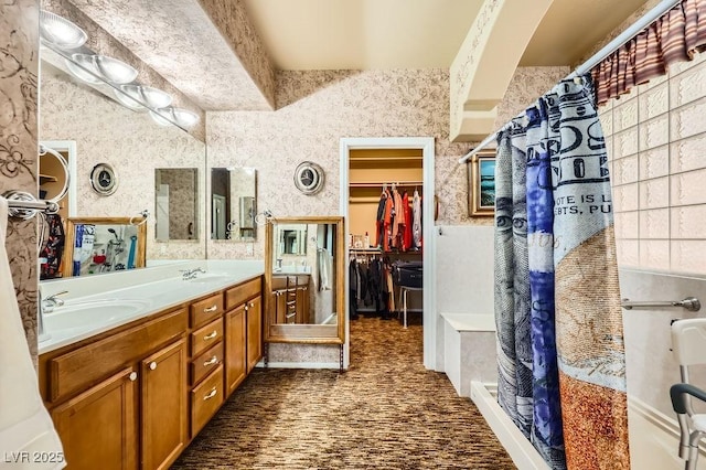 215 Sunset Shower Dr, Henderson, NV 89012 - full bathroom featuring a walk in closet, wallpapered walls, a shower stall, and a sink