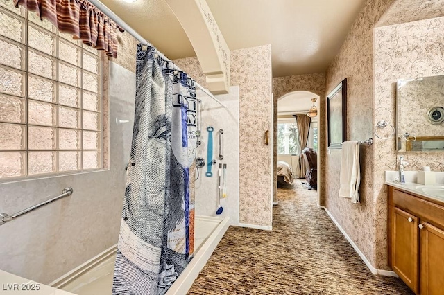 215 Sunset Shower Dr, Henderson, NV 89012 - bathroom with a shower with curtain, baseboards, vanity, and ensuite bath