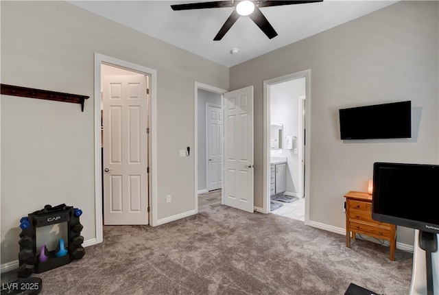 unfurnished bedroom featuring ceiling fan, baseboards, carpet, and ensuite bath