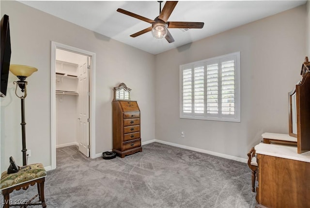carpeted bedroom with a closet, a spacious closet, ceiling fan, and baseboards