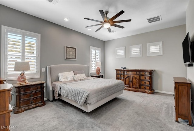 carpeted bedroom featuring recessed lighting, visible vents, multiple windows, and baseboards