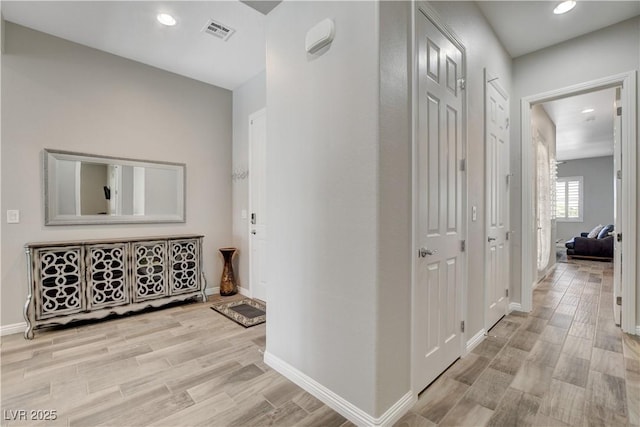 corridor featuring recessed lighting, light wood finished floors, visible vents, and baseboards