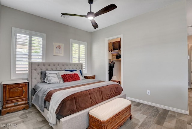 bedroom with light wood-type flooring, baseboards, a ceiling fan, and visible vents