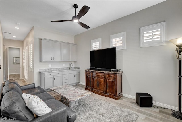living area with visible vents, baseboards, ceiling fan, recessed lighting, and light wood-style flooring