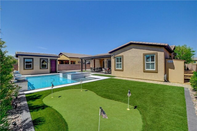 view of pool featuring a patio, a fenced backyard, a pool with connected hot tub, and an outdoor structure