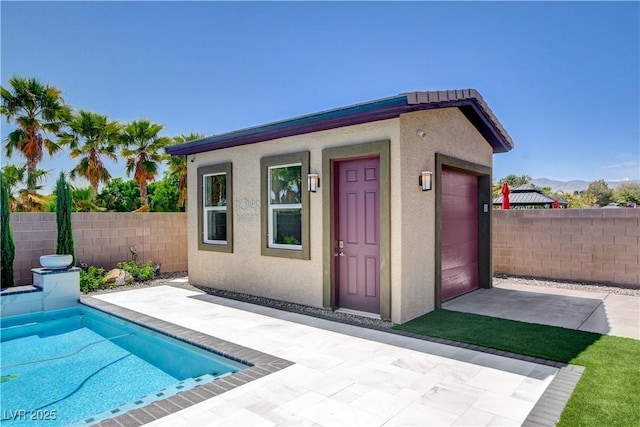 view of outbuilding featuring a fenced in pool and fence