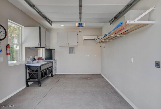 garage featuring a garage door opener, baseboards, and electric panel