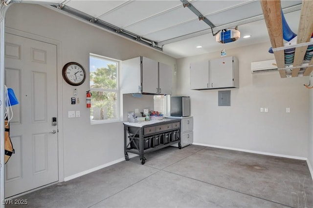 garage with recessed lighting, baseboards, and a garage door opener