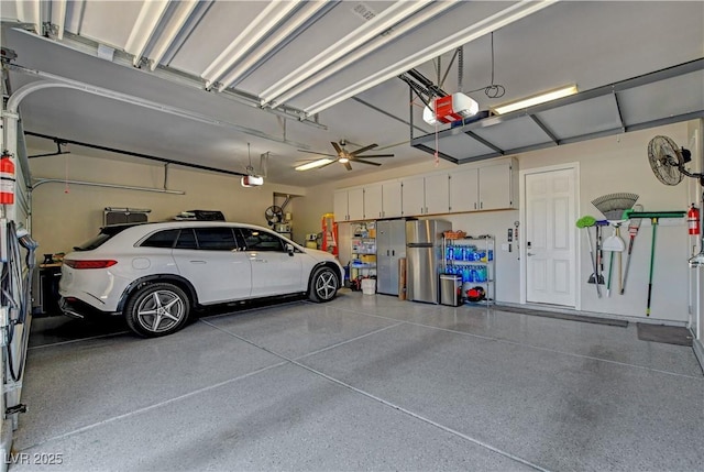garage featuring freestanding refrigerator and a garage door opener