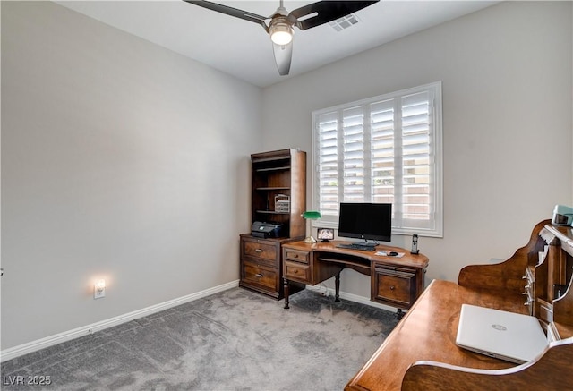 carpeted home office featuring visible vents, baseboards, and a ceiling fan