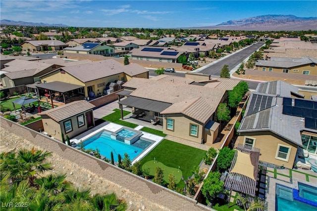 drone / aerial view featuring a residential view and a mountain view