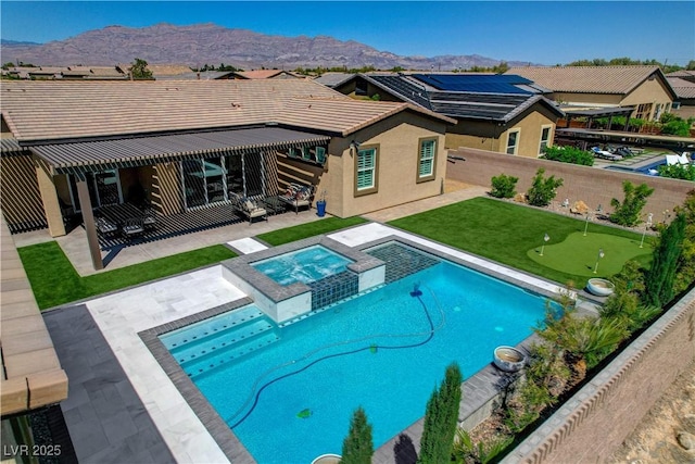 rear view of house featuring stucco siding, a mountain view, a patio area, a fenced backyard, and a pool with connected hot tub