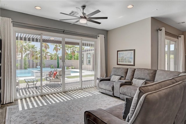 living room with recessed lighting, plenty of natural light, wood finished floors, and ceiling fan