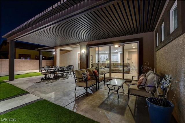 patio at twilight with an outdoor living space, fence, and outdoor dining space