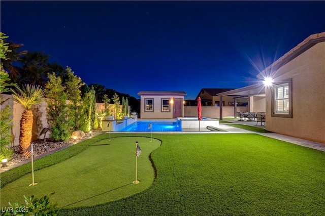 pool at twilight with an outbuilding, a fenced backyard, a fenced in pool, and a patio