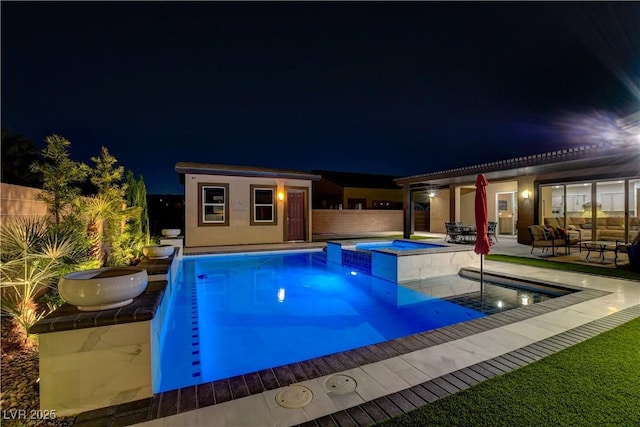 pool at twilight featuring a patio area, a fenced backyard, an outdoor structure, and a pool with connected hot tub