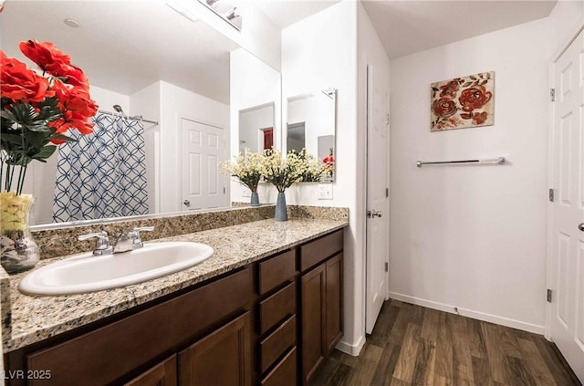 1035 Spotted Saddle St, Henderson, NV 89015 - full bath with baseboards, a shower with shower curtain, vanity, and wood finished floors