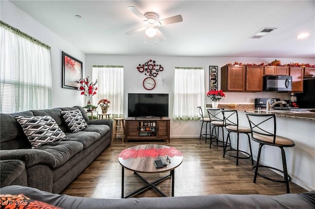 1035 Spotted Saddle St, Henderson, NV 89015 - living room with plenty of natural light, visible vents, ceiling fan, and wood finished floors