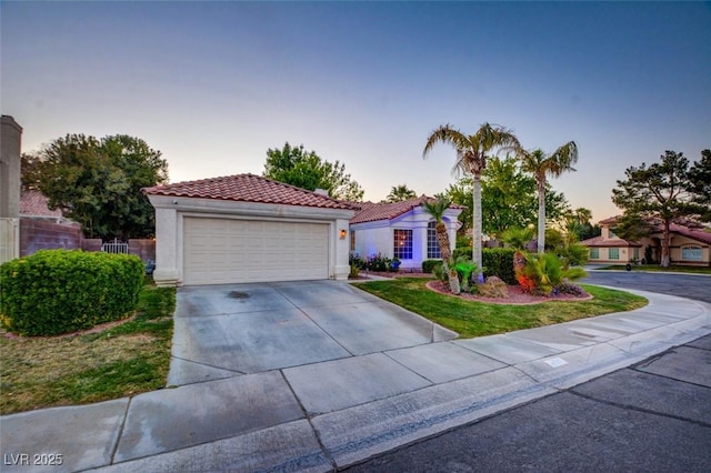 4517 Inez Dr, Las Vegas, NV 89130 - mediterranean / spanish-style house featuring a tiled roof, a garage, stucco siding, and driveway