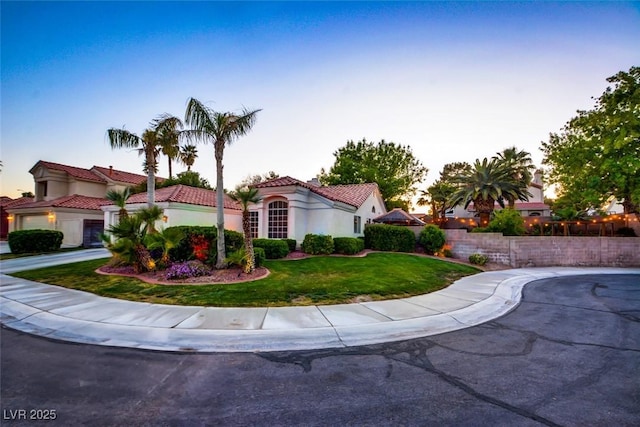 4517 Inez Dr, Las Vegas, NV 89130 - mediterranean / spanish-style house featuring stucco siding, a tiled roof, and a lawn