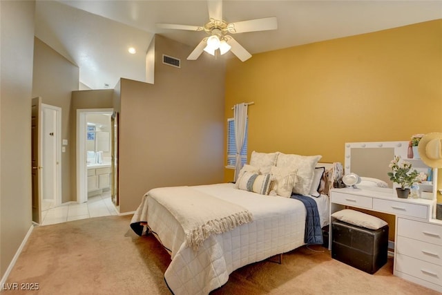 4517 Inez Dr, Las Vegas, NV 89130 - bedroom with high vaulted ceiling, light carpet, baseboards, ceiling fan, and ensuite bath
