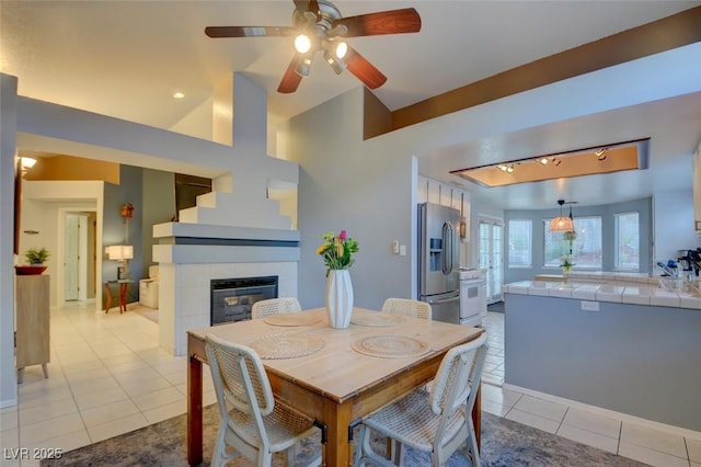 4517 Inez Dr, Las Vegas, NV 89130 - dining space with light tile patterned floors, a fireplace, and ceiling fan