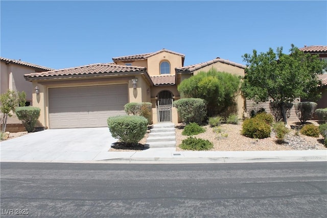 932 Tafalla Ct, Las Vegas, NV 89138 - mediterranean / spanish house with an attached garage, driveway, stucco siding, and a tile roof