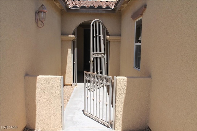 932 Tafalla Ct, Las Vegas, NV 89138 - entrance to property with stucco siding, a tiled roof, and a gate