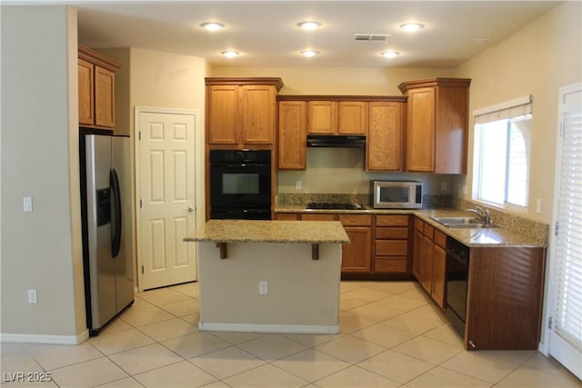 932 Tafalla Ct, Las Vegas, NV 89138 - kitchen featuring a sink, visible vents, brown cabinetry, and black appliances