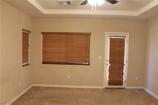 932 Tafalla Ct, Las Vegas, NV 89138 - carpeted spare room featuring a tray ceiling, baseboards, a ceiling fan, and visible vents
