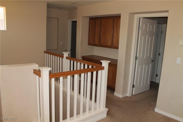 932 Tafalla Ct, Las Vegas, NV 89138 - corridor featuring baseboards, an upstairs landing, and light carpet