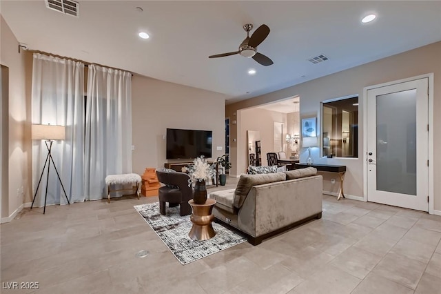 living area with a ceiling fan, visible vents, and recessed lighting