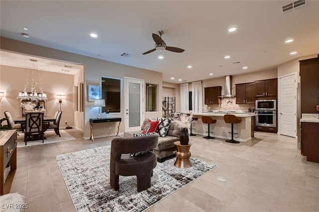 living area featuring light tile patterned floors, visible vents, recessed lighting, and ceiling fan
