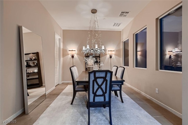 dining space with an inviting chandelier, visible vents, and baseboards