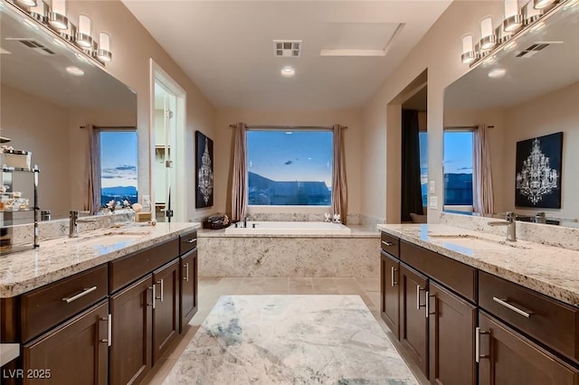 full bathroom featuring tile patterned flooring, visible vents, a garden tub, and a sink