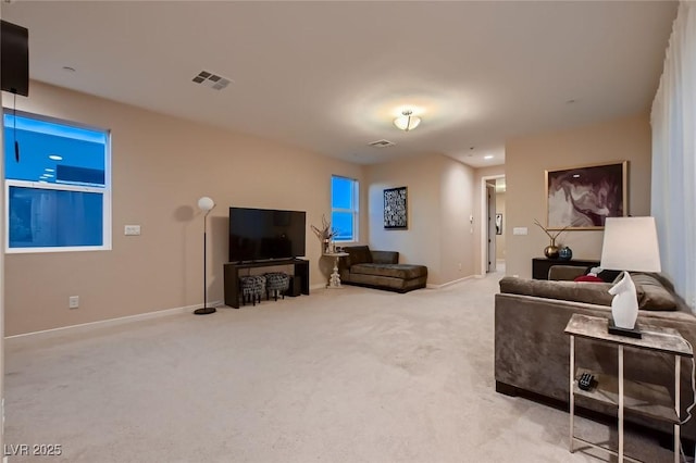 living area with baseboards, visible vents, and carpet floors