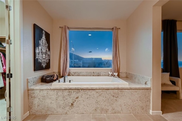 full bathroom featuring tile patterned floors and a garden tub