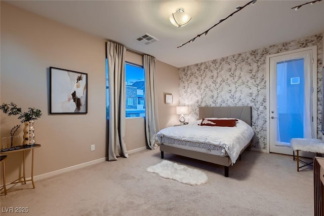carpeted bedroom featuring baseboards and visible vents