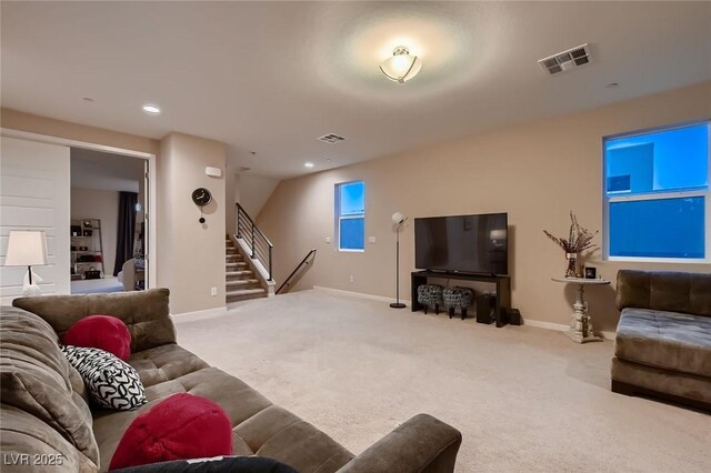 living area with baseboards, stairs, visible vents, and carpet