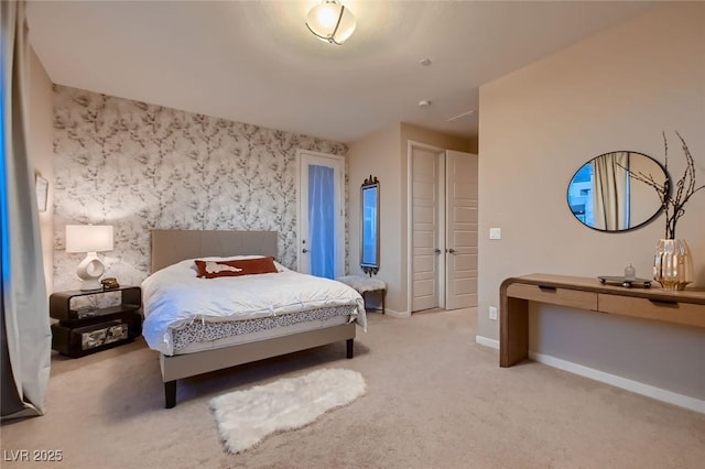 carpeted bedroom featuring wallpapered walls and baseboards