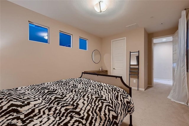 bedroom with light carpet and baseboards