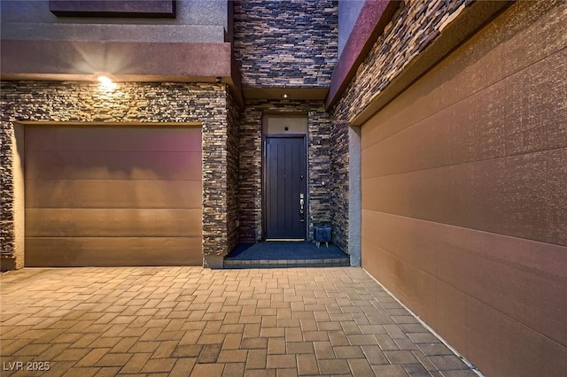view of exterior entry with a garage