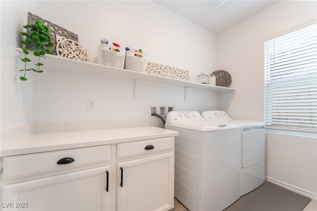 laundry room featuring baseboards, separate washer and dryer, laundry area, and a healthy amount of sunlight